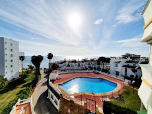 an overhead view of a swimming pool in a building at Cozy Apartment on the Beach in Sitio de Calahonda