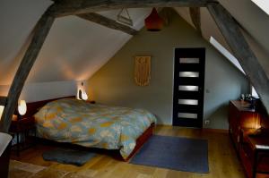a bedroom with a bed in a attic at La Charmeraie Wellness & SPA in Lacroix-Saint-Ouen