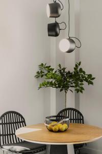 a dining room table with a potted plant and chairs at Aposperia Memorable Living in Kyra Panagia