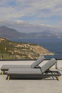 a couch on a balcony with a view of the ocean at Aposperia Memorable Living in Kyra Panagia