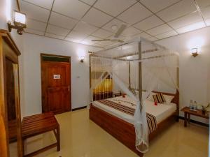 Postel nebo postele na pokoji v ubytování Nimsara Lodge Sigiriya