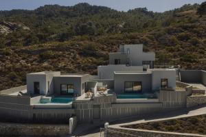 an aerial view of a white house on a hill at Aposperia Memorable Living in Kyra Panagia