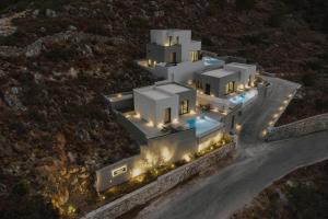 an aerial view of a house with lights on a mountain at Aposperia Memorable Living in Kyra Panagia