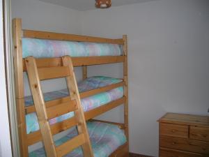 a wooden bunk bed with a ladder in a room at LELEX, MONTS JURA, LES ETALES 26 in Lélex