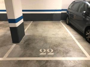 a parking lot with a car parked in it at Piso Reformado a 2 Min del Casco Viejo Con Garaje Gratis in Bilbao