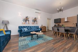 a living room with a blue couch and a table at Dante paradiso in Pula