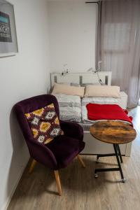 ein Schlafzimmer mit einem Bett, einem Stuhl und einem Tisch in der Unterkunft 1 Zimmer Wohnung mit der Terrasse in der Innenstadt in Wiesbaden