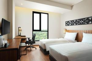 BATIQA Hotel Pekanbaru客房内的一张或多张床位