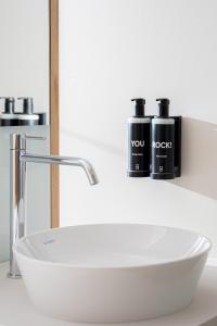 a bathroom sink with two bottles on a counter at Ocean Drive Madrid in Madrid