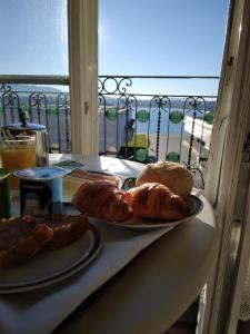 a table with two plates of bread and a window at Hotel Jardim Viana do Castelo in Viana do Castelo