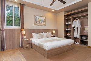 a bedroom with a large bed and a window at Anik Boutique Hotel & Spa on Norodom Blvd in Phnom Penh