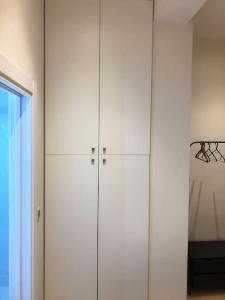 a large white cabinet in a room with a window at Lovely Apartament in Málaga