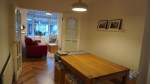 a living room with a wooden table and a living room at Portallo Peace: a sanctuary in the city. in Belfast