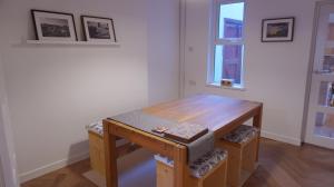 a wooden table in a room with a window at Portallo Peace: a sanctuary in the city. in Belfast