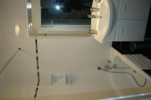 a bathroom with a toilet and a sink and a mirror at Appartement Les Romanesques in Cambo-les-Bains