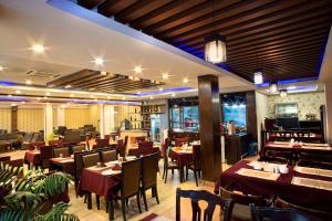 una sala da pranzo con tavoli e sedie in un ristorante di The Address Kathmandu Hotel a Kathmandu