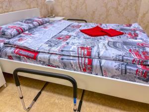 a bed with a blanket on top of it at London Mini-hotel in Yekaterinburg