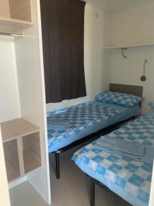 a room with two beds and a window at Abbatoggia Village in La Maddalena