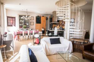 a living room with a white couch and a table at Appartement terrasse 3*dominant St Martin de Ré in Saint-Martin-de-Ré