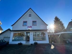 a store front of a building with the sun behind it at Waldblick in Herford