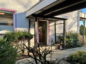 a house with a front porch with a door at Waldblick in Herford