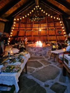 a large room with a fire pit in a building at Kvamshaugen hytter in Luster