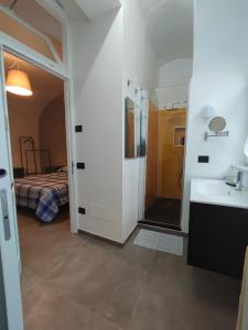 a bathroom with a shower and a sink and a mirror at CASA VACANZE - ANTICO CONVENTO in Salerno