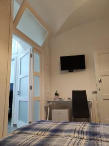 Televízia a/alebo spoločenská miestnosť v ubytovaní CASA VACANZE - ANTICO CONVENTO