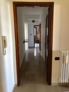 einen Flur mit einer Tür, die in ein Zimmer führt in der Unterkunft La Pigna Verde in Taranto