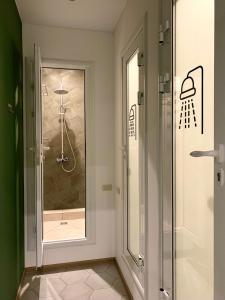 a shower in a bathroom with a glass door at GREEN hostel in Turgoyak