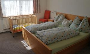 A bed or beds in a room at Pension Tannheim
