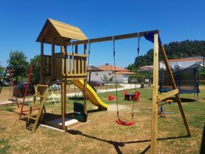 a playground with a slide and swings at Annmari Studios in Skala Potamias