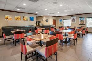 a dining room with tables and chairs in a restaurant at Comfort Inn & Suites St Louis-O'Fallon in O'Fallon