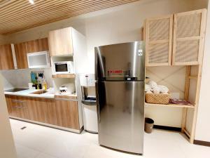 a stainless steel refrigerator in a small kitchen at 挈客茵民宿 in Zhushan +7 photos