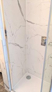 a shower with a white marble shower stall at The Little Limes - Ensuite Double Room Own Entrance in Art Deco House in Kent