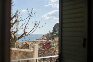 a view of a city from a window of a house at Donna Saretta Casetta tradizionale Amalfitana in Amalfi