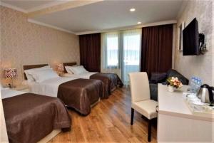 Rúm í herbergi á Hotel King David Bakuriani