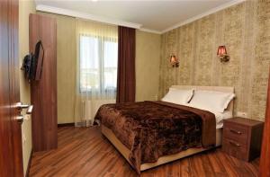 Rúm í herbergi á Hotel King David Bakuriani