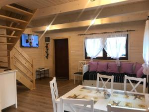 a living room with a couch and a table at „ Lawendowy zakątek”/„Lavender cottage” in Żywiec in Żywiec