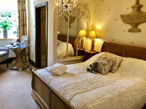 a bedroom with a large bed with a large mirror at The Priory in Scorton