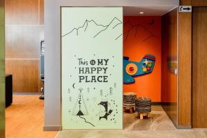 a sign that says this way happy place at Acta Arthotel in Andorra la Vella