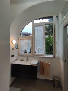 a bathroom with a sink and a window at CASA VACANZE - ANTICO CONVENTO in Salerno