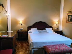 Posteľ alebo postele v izbe v ubytovaní Hotel Simon
