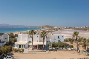 an aerial view of a white house with palm trees at Alykes Studios & Suites in Agios Prokopios
