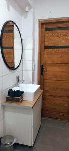 a bathroom with a white sink and a wooden door at Apartment Rajzefiber - Spodek - MCK - NOSPR in Katowice +23 photos