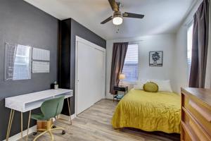 a bedroom with a bed and a desk and a ceiling fan at 18th Street A in Boise