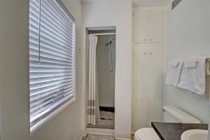 a bathroom with a shower and a toilet and a window at 18th Street A in Boise +25 photos