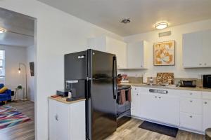 a kitchen with a stainless steel refrigerator and white cabinets at 18th Street A in Boise