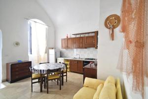 a living room with a table and a kitchen at Camera vista mare Holidayz in Gallipoli +20 photos