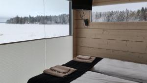 Postel nebo postele na pokoji v ubytování Kipinä Lomat - Tuli-mökki + 2 fotografie